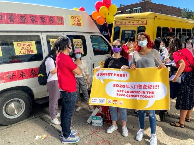 Poster held by two people says Get Counted in the 2020 Census!