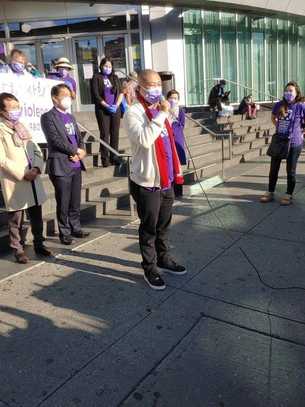 Mitch Wu speaks at the rally on the steps outside of the Flushing Library