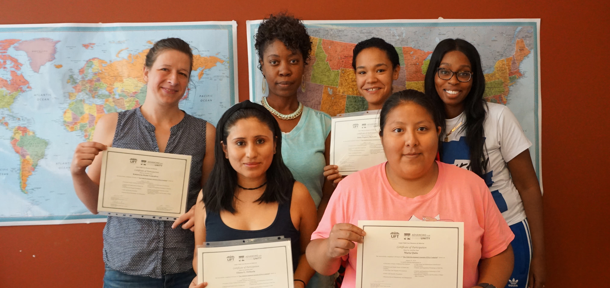 Women holding certifications awards