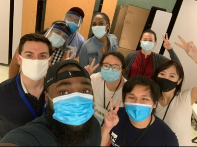 A group wearing masks smiling for the camera