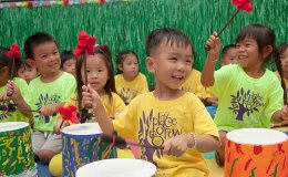 Children playing drums in a classroom