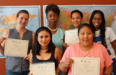 Women holding certifications awards