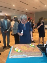 UNH Executive Director Susan Stamler Cutting the UNH Birthday Cake