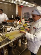 Sitora spreading avocado on bread