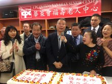 Speakers in front of two cakes