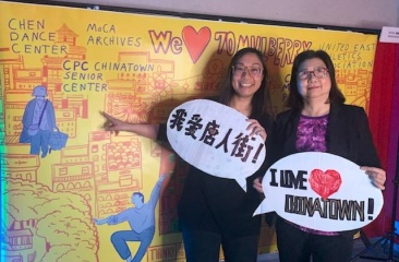 Kim To (left), Chief Development Officer, and Christina Wong (right), Assistant Director of CPC Chinatown Senior Center, pose in front of mural created for Chinatown Fire Relief Fundraiser