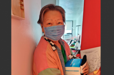 Hong Ning Resident holds their box of masks.