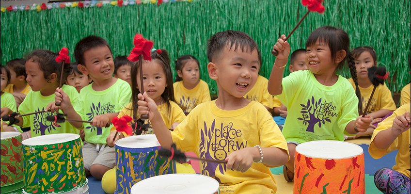 Children playing drums in a classroom