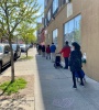 Older adults wait at an appropriate distance for a food share.